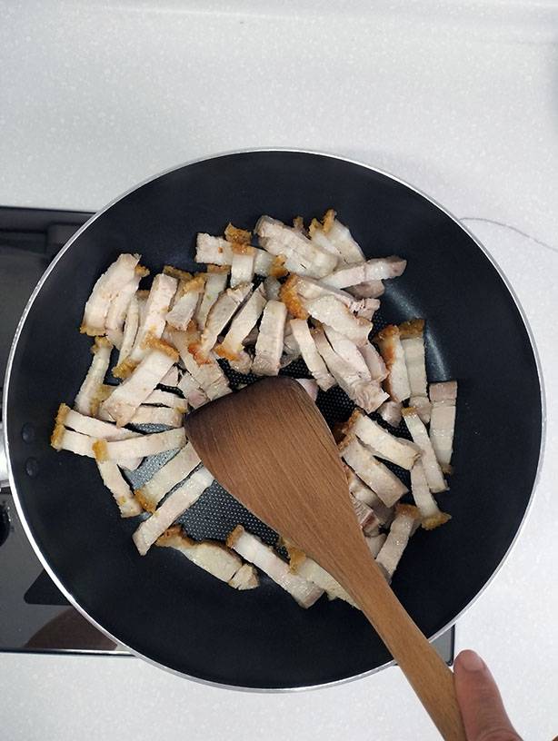 Stir fry overnight leftover pork belly with a spatula.