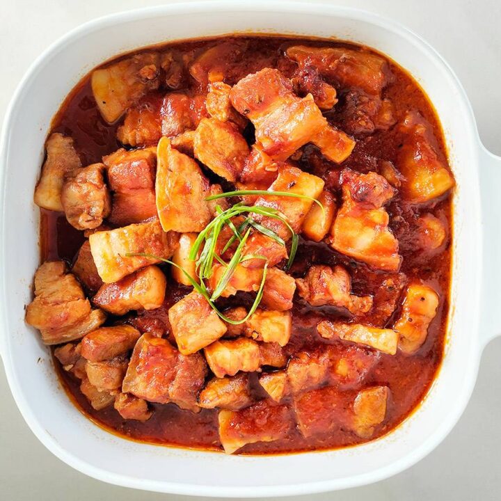 Italian inspired passata braised pork belly garnished in a bowl.