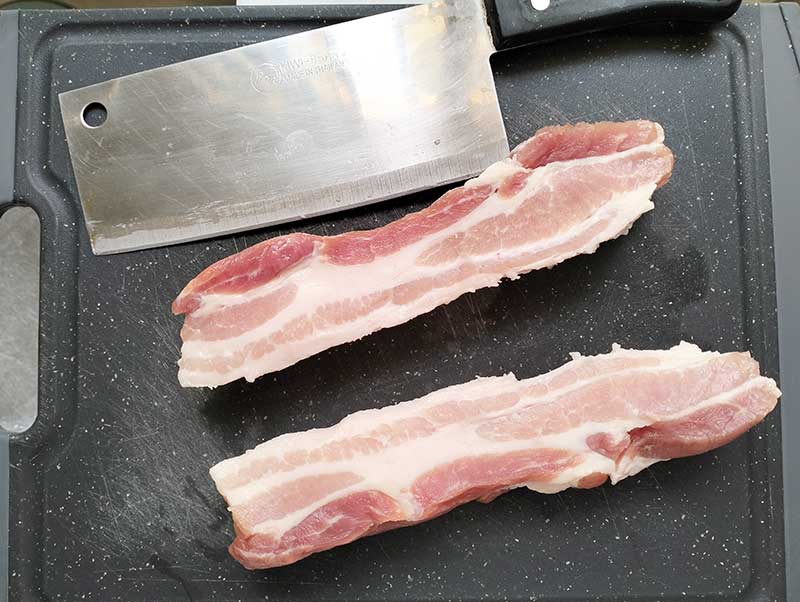 cut pork belly on cutting board