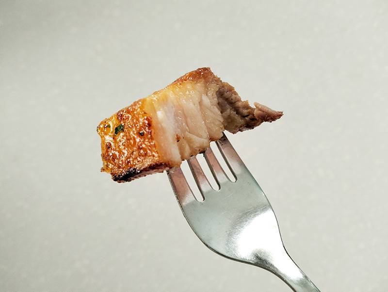juicy pork belly with a fork
