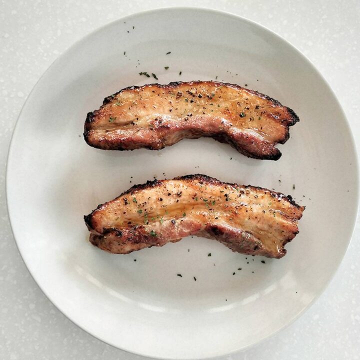 Air fried Pork Belly Strips on the white plate