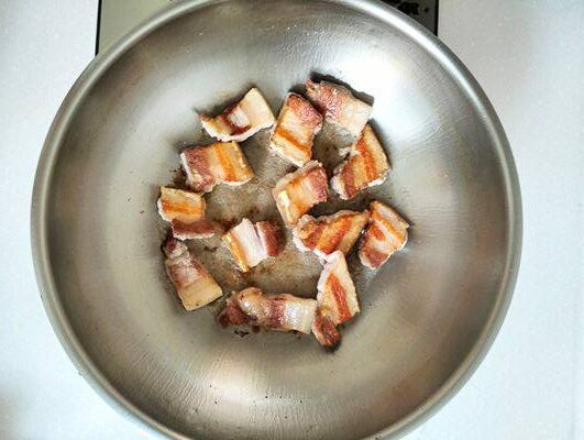 Searing pork belly in stainless steel wok