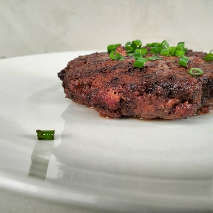 cooked cocoa pork patty on plate